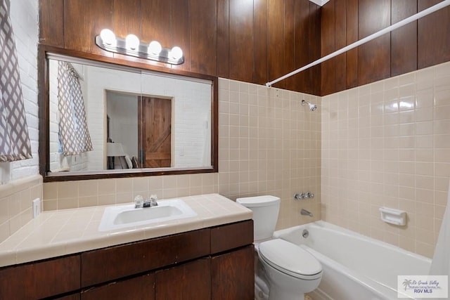 full bath featuring tasteful backsplash, tub / shower combination, vanity, and toilet