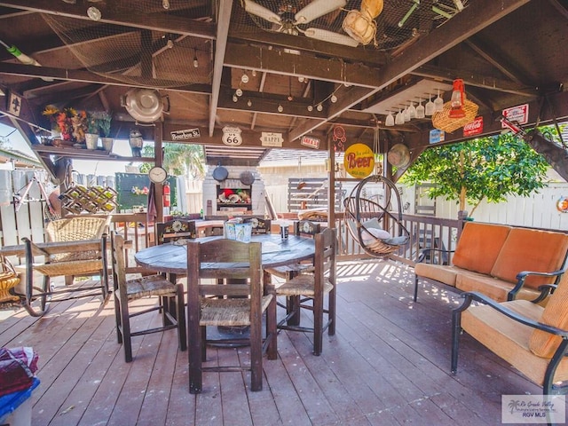 wooden deck featuring outdoor lounge area and ceiling fan