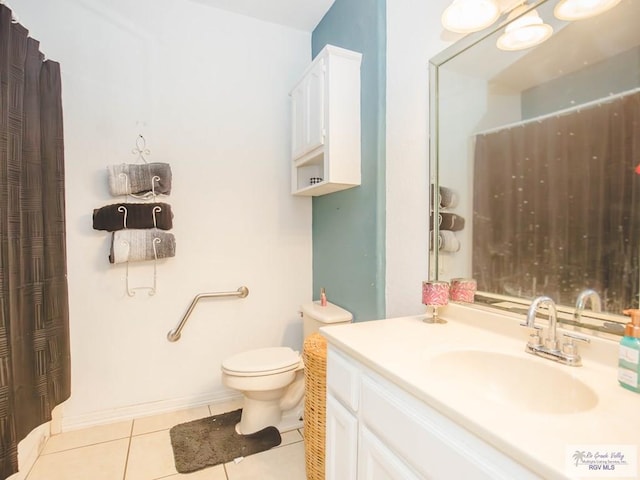 bathroom with tile patterned floors, vanity, and toilet