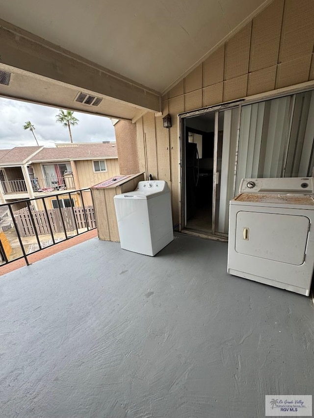 view of patio with visible vents, independent washer and dryer, and a balcony