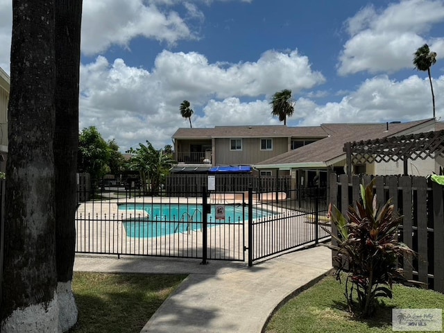 pool featuring a patio area and fence