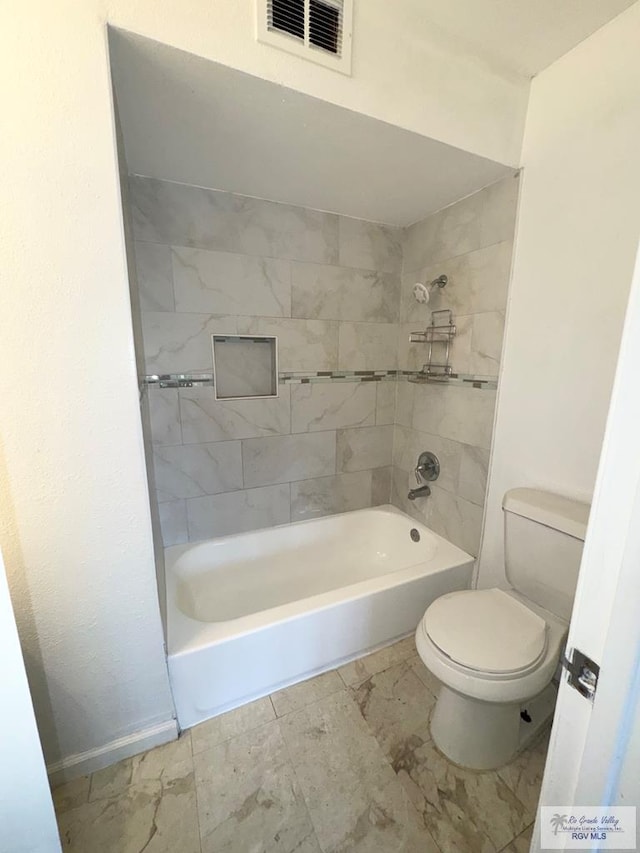 bathroom with visible vents, tub / shower combination, toilet, and baseboards