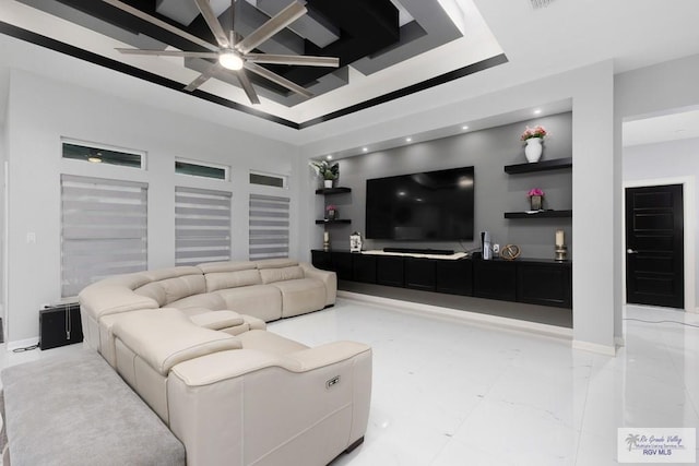 711 Santa Elena St, Weslaco, TX 78596 - living room with a tray ceiling, ceiling fan, and baseboards