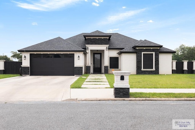 711 Santa Elena St, Weslaco, TX 78596 - view of front of house featuring a garage, concrete driveway, roof with shingles, and a front yard