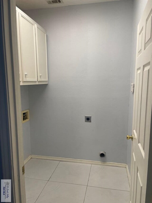 2776 Fleet St, Brownsville, TX 78521 - laundry area with electric dryer hookup, cabinet space, hookup for a washing machine, tile patterned flooring, and baseboards