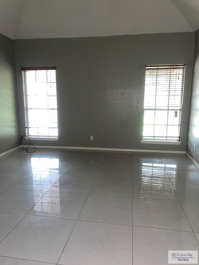 2776 Fleet St, Brownsville, TX 78521 - tiled spare room featuring baseboards and lofted ceiling