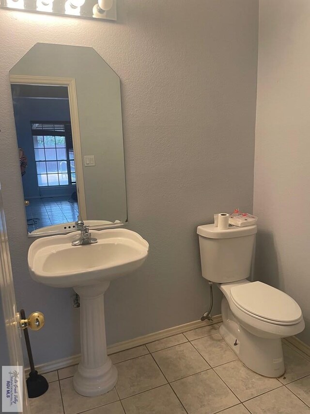 2776 Fleet St, Brownsville, TX 78521 - bathroom featuring toilet, tile patterned floors, and baseboards