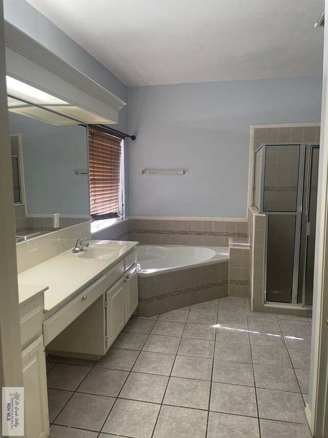 2776 Fleet St, Brownsville, TX 78521 - bathroom featuring vanity, a bath, tile patterned flooring, and a shower stall