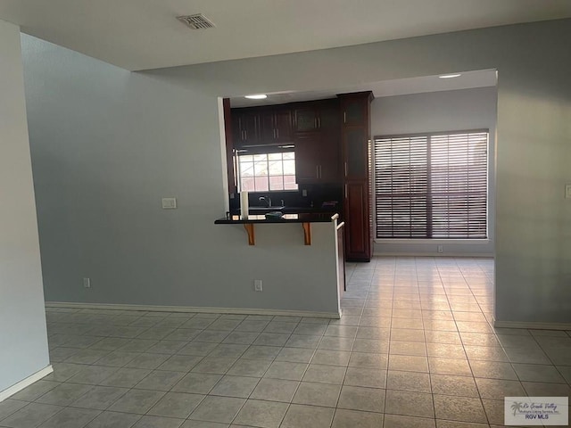 2776 Fleet St, Brownsville, TX 78521 - empty room featuring light tile patterned flooring, baseboards, and a sink