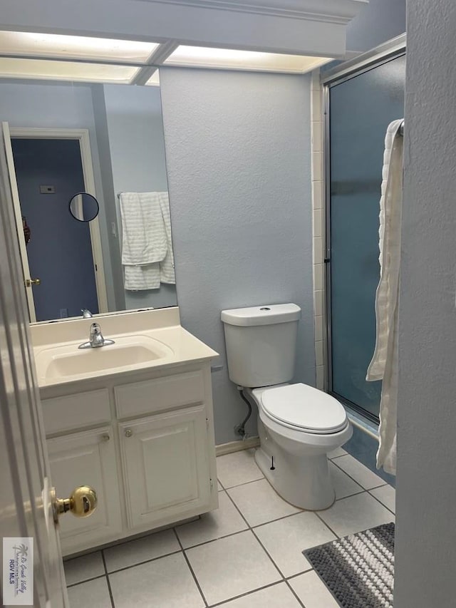 2776 Fleet St, Brownsville, TX 78521 - full bathroom with vanity, tile patterned flooring, a stall shower, and toilet