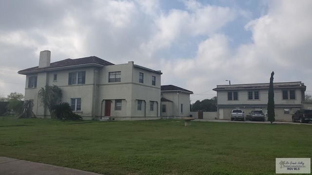 view of front of property featuring a front lawn and a garage