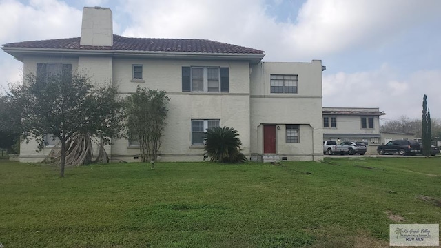 back of house with a yard