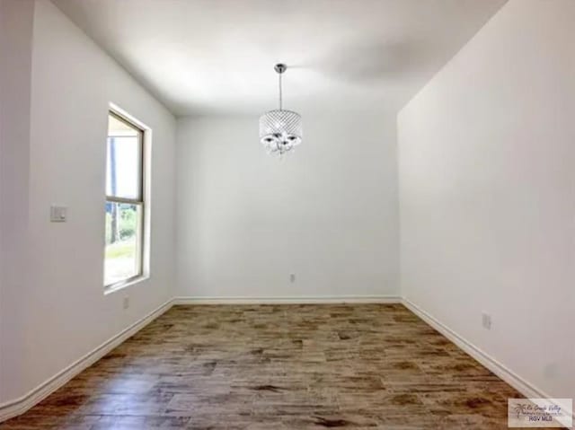 17134 Mandarin Ave, Harlingen, TX 78552 - unfurnished dining area featuring a chandelier, wood finished floors, and baseboards