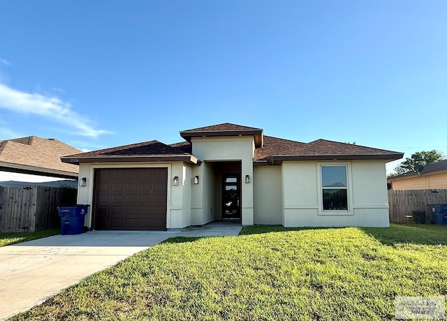 17134 Mandarin Ave, Harlingen, TX 78552 - view of front of home with stucco siding, a garage, concrete driveway, and a shingled roof
