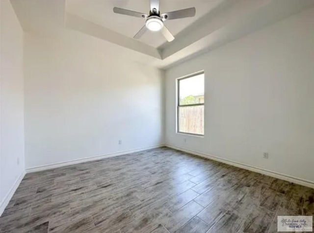 17134 Mandarin Ave, Harlingen, TX 78552 - unfurnished room featuring a raised ceiling, wood finished floors, baseboards, and ceiling fan
