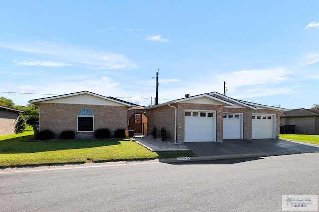 single story home featuring a front yard and a garage