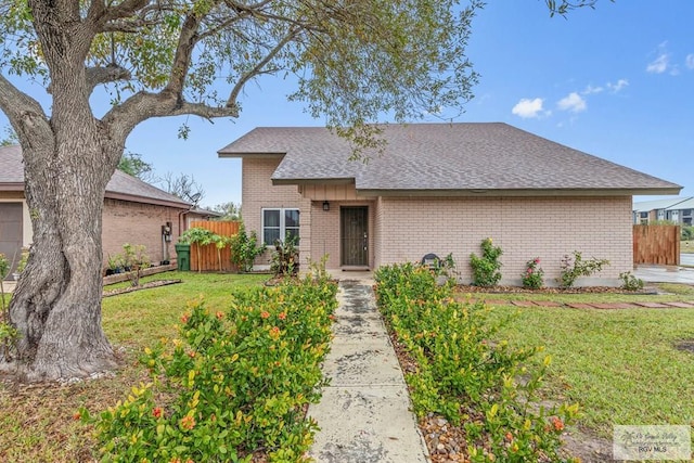 ranch-style home featuring a front yard