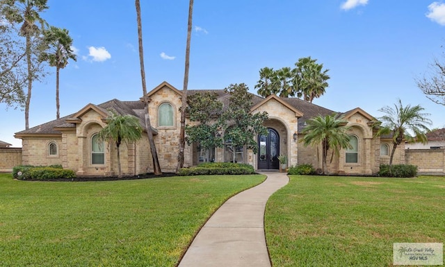 mediterranean / spanish-style home with a front lawn