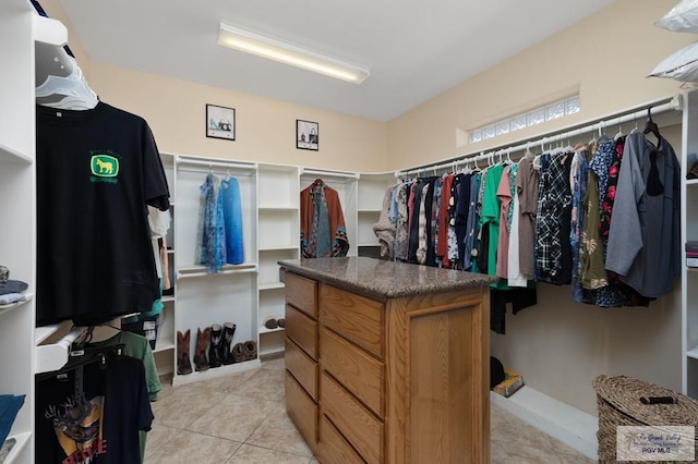 walk in closet featuring light tile patterned flooring