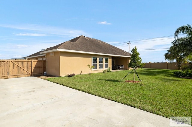 rear view of house with a lawn