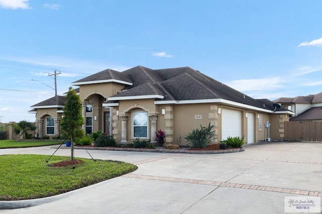 view of front of house featuring a front lawn and a garage