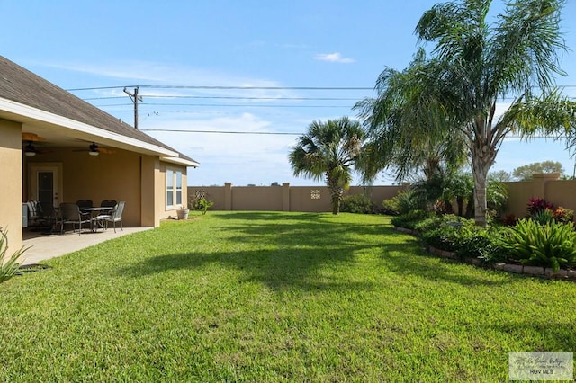 view of yard featuring ceiling fan and a patio area