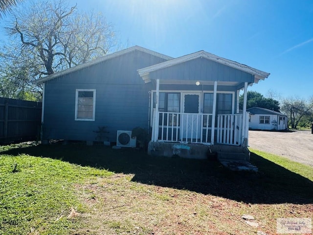1400 Milpa Verde, Brownsville, TX 78521 - view of front of home featuring a porch, fence, a front lawn, and ac unit
