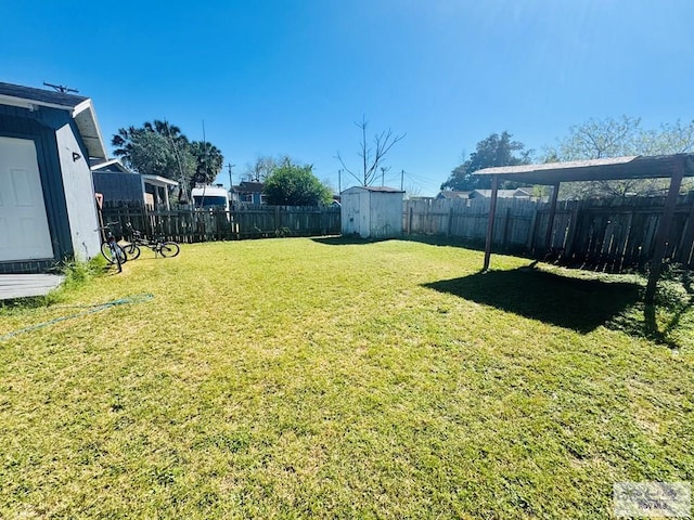 1400 Milpa Verde, Brownsville, TX 78521 - view of yard featuring a storage unit, a fenced backyard, and an outdoor structure