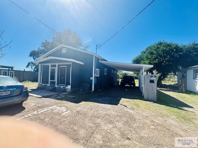 1400 Milpa Verde, Brownsville, TX 78521 - view of front of property featuring an attached carport and dirt driveway
