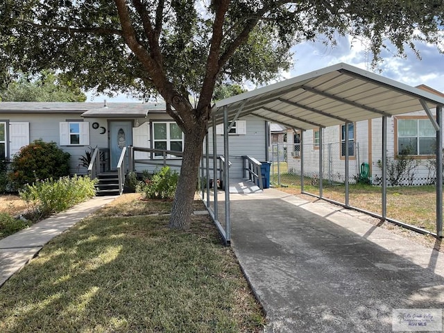 view of front of property with a carport and a front lawn