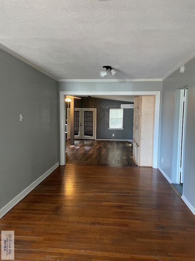 unfurnished living room with ornamental molding, dark wood-type flooring, and a textured ceiling