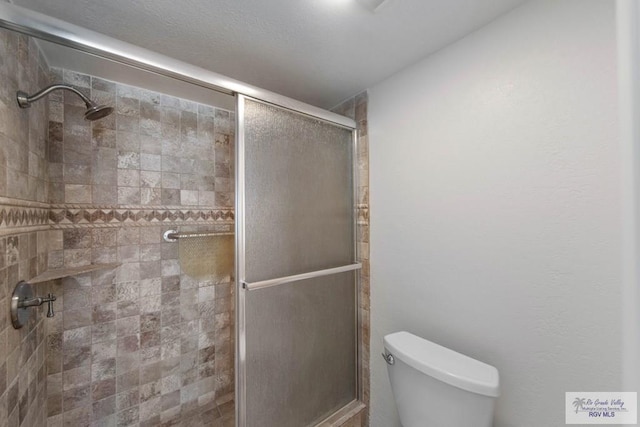 bathroom featuring toilet and walk in shower