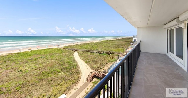 balcony with a view of the beach and a water view