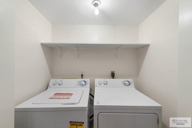 clothes washing area featuring washer and dryer