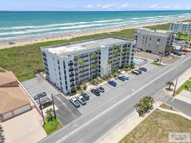 birds eye view of property featuring a water view and a beach view