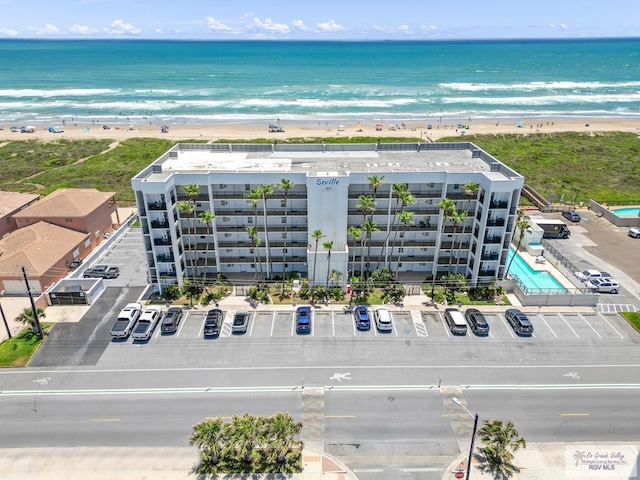 drone / aerial view featuring a water view and a view of the beach