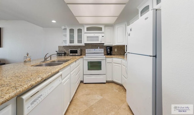 kitchen with white cabinetry, sink, light stone counters, white appliances, and decorative backsplash