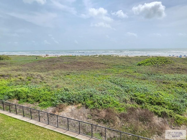 view of yard with fence and a water view