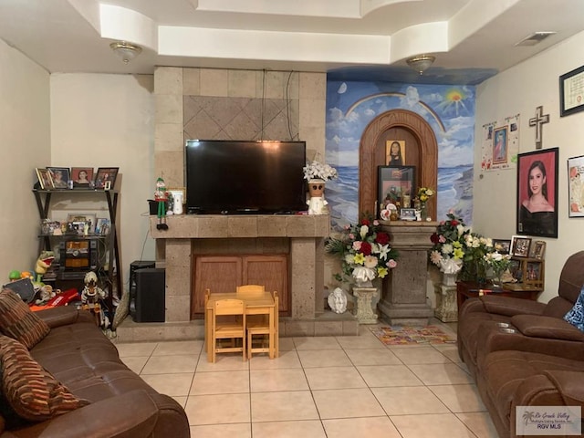 2310 Tiffany Dr, Mission, TX 78574 - living area featuring light tile patterned flooring, a fireplace, and a raised ceiling