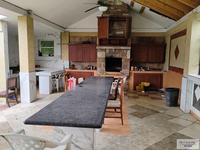 kitchen with vaulted ceiling with beams, ceiling fan, and decorative backsplash