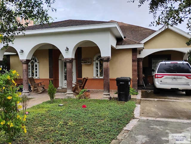 2310 Tiffany Dr, Mission, TX 78574 - view of front of property with stucco siding, a shingled roof, and concrete driveway
