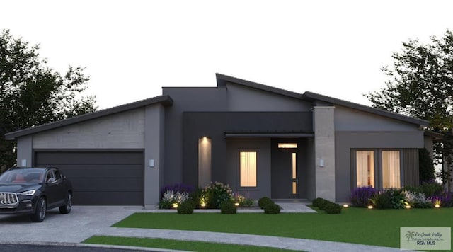 view of front facade with a garage, driveway, a front lawn, and stucco siding