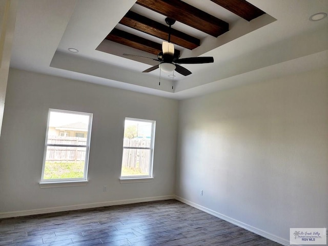 unfurnished room with a raised ceiling, hardwood / wood-style flooring, ceiling fan, and beamed ceiling