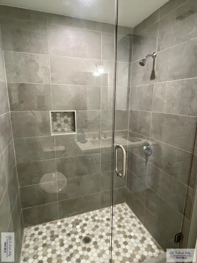 bathroom with a shower stall