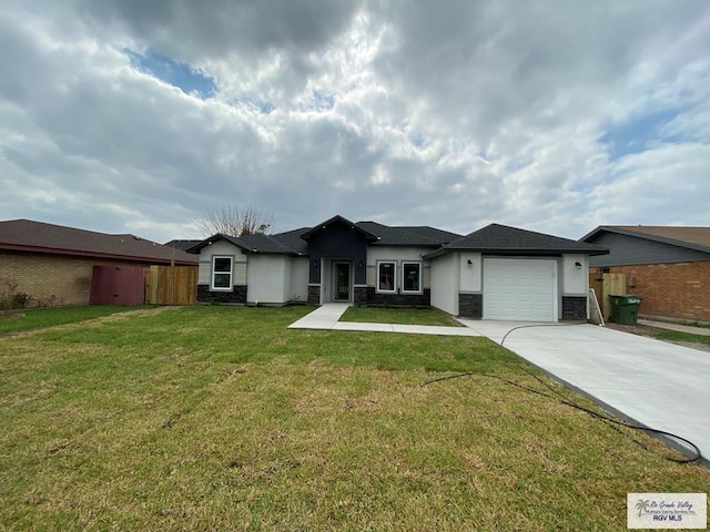 view of front of house featuring a garage, driveway, stone siding, stucco siding, and a front yard