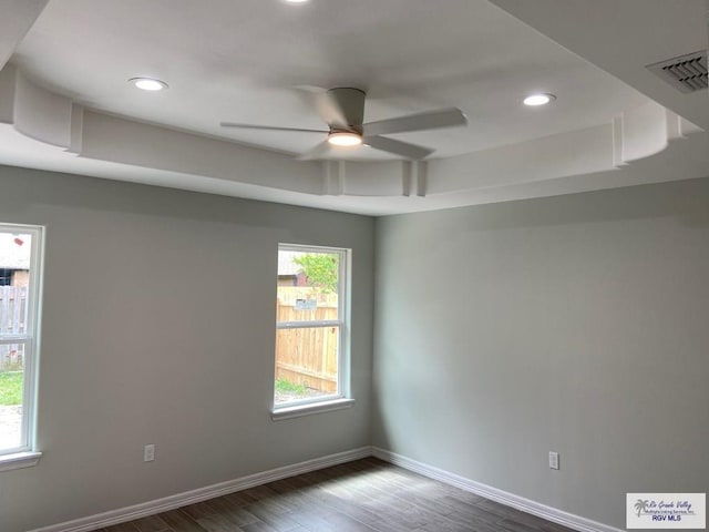 empty room featuring visible vents, baseboards, wood finished floors, and recessed lighting