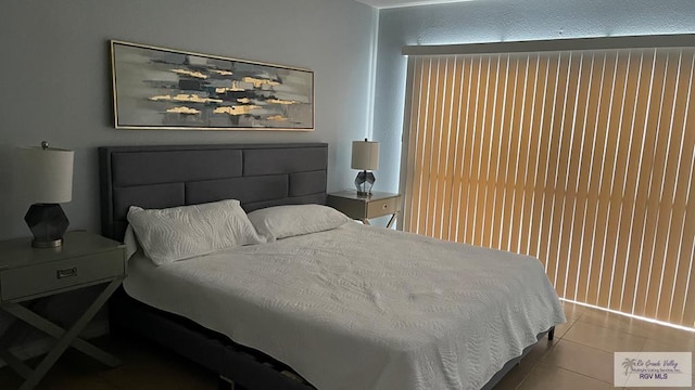 bedroom with light tile patterned floors