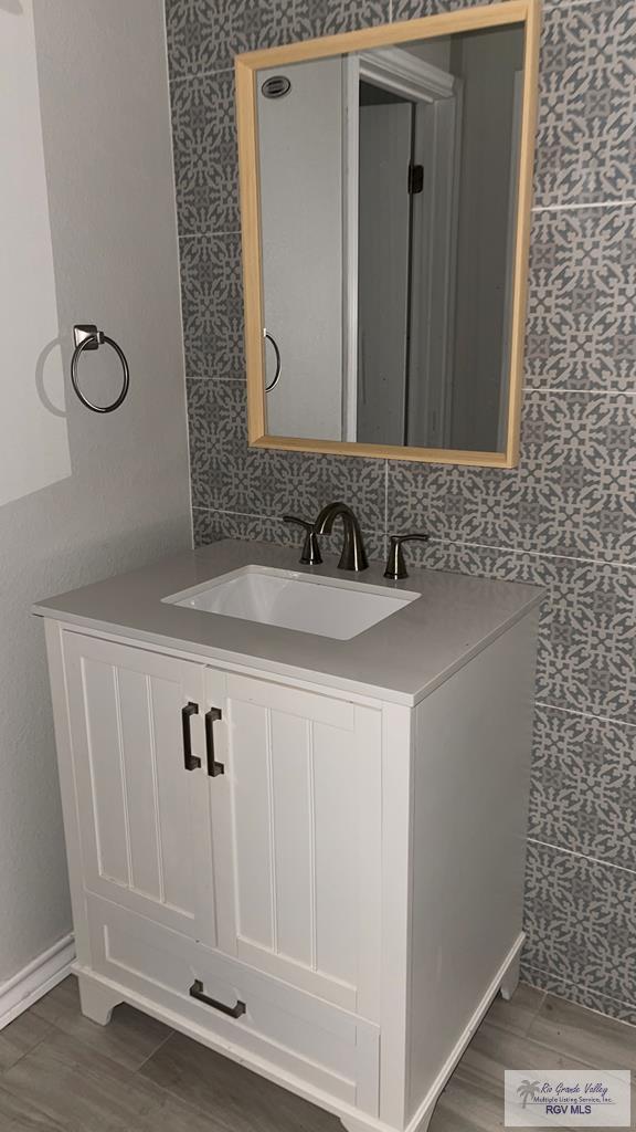 bathroom with hardwood / wood-style flooring and vanity