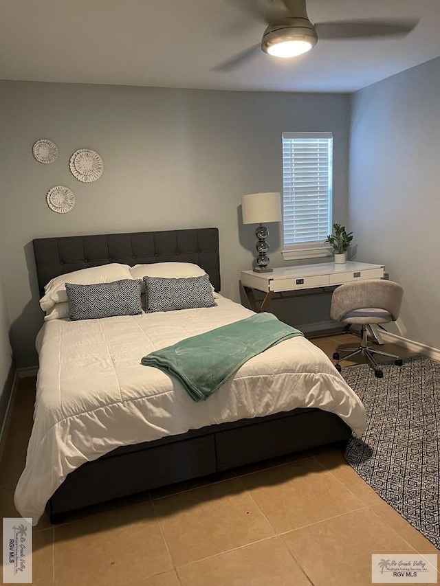 tiled bedroom featuring ceiling fan