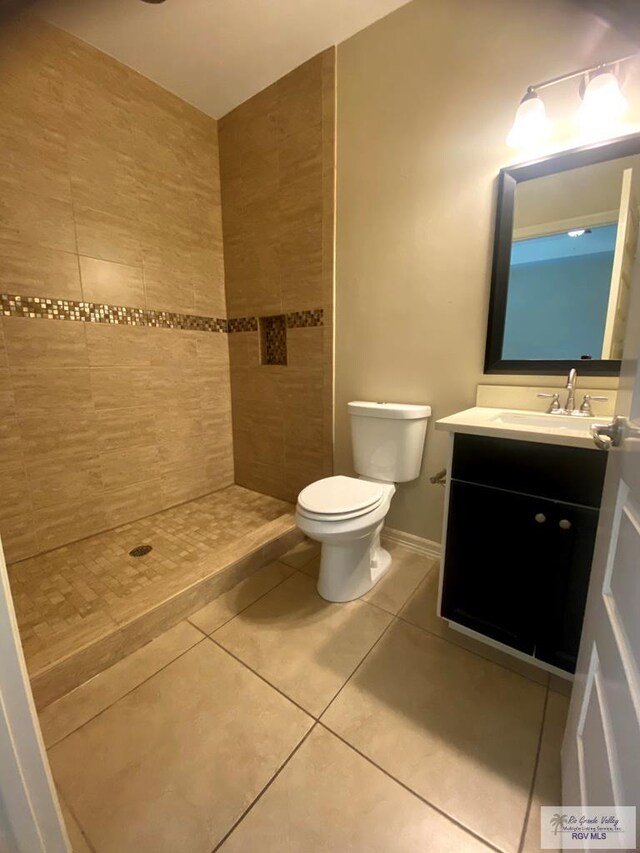 116 Village E Dr, Los Fresnos, TX 78566 - bathroom with tile patterned floors, vanity, toilet, and a tile shower